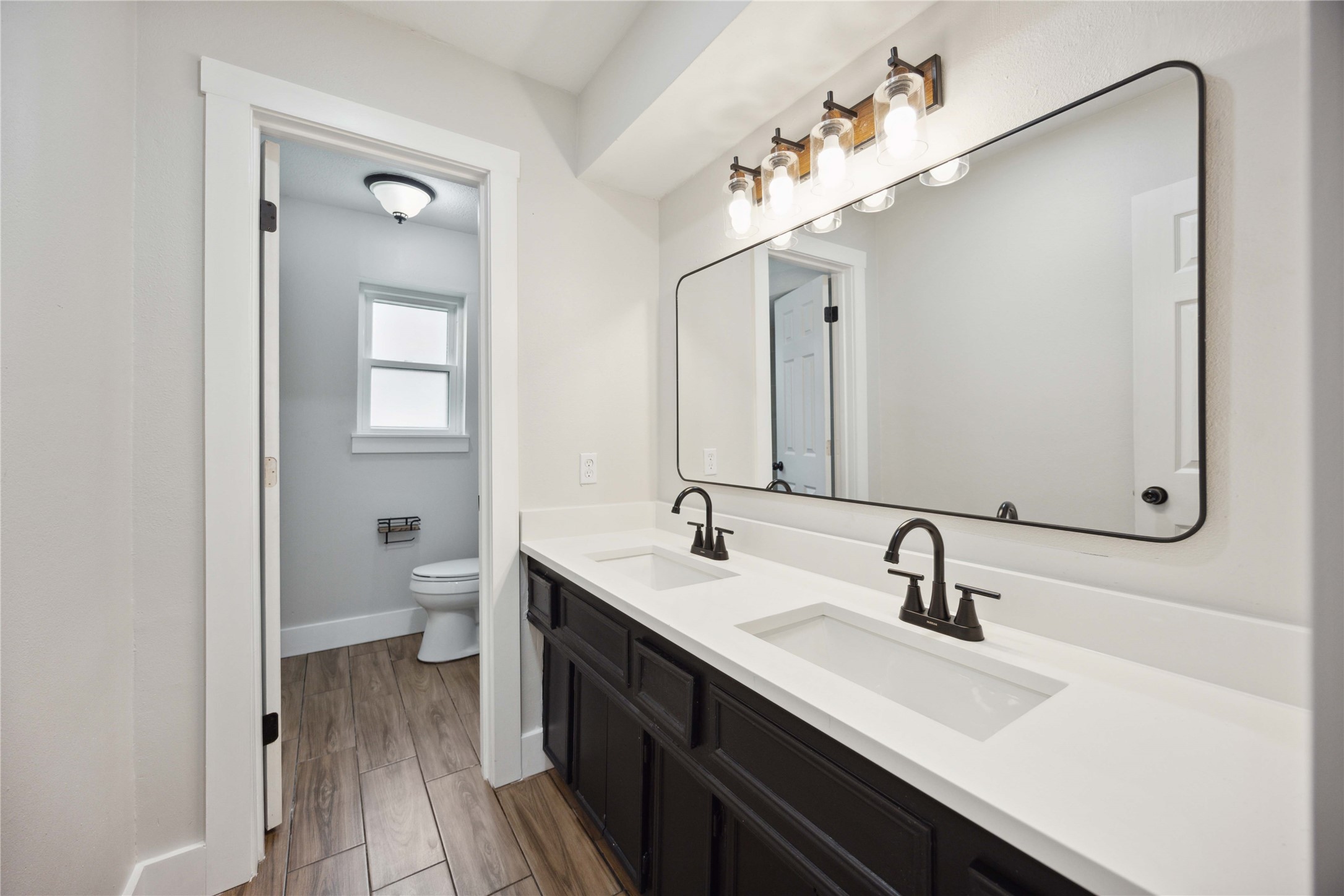 7907 12 Fairway Lane Humble, TX 77346 - Photo 28 of 42 a bathroom with a double vanity sink mirror and toilet