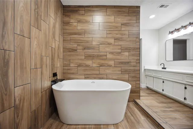 a view of a room with wooden floor and a bathroom