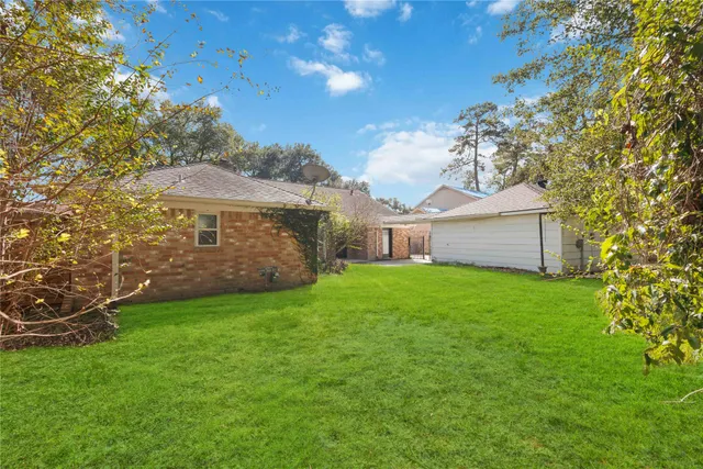 a backyard of a house with table and chairs