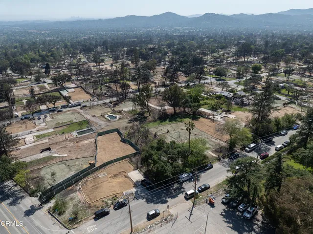 an aerial view of residential house with green space