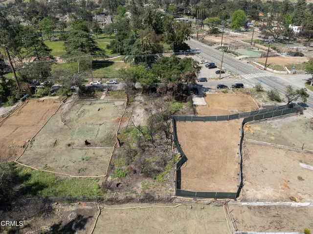 an aerial view of a house with a yard