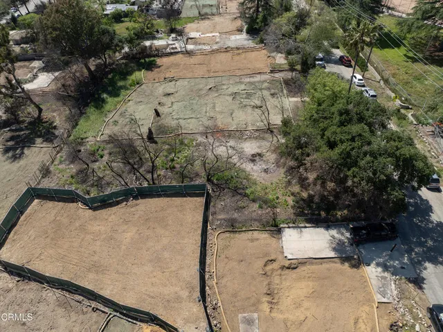 an aerial view of a house with a yard