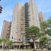 a view of a tall building next to a road