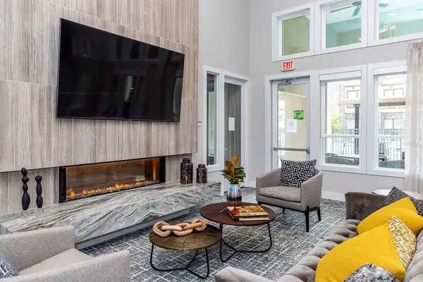 a living room with furniture a flat screen tv and a fireplace