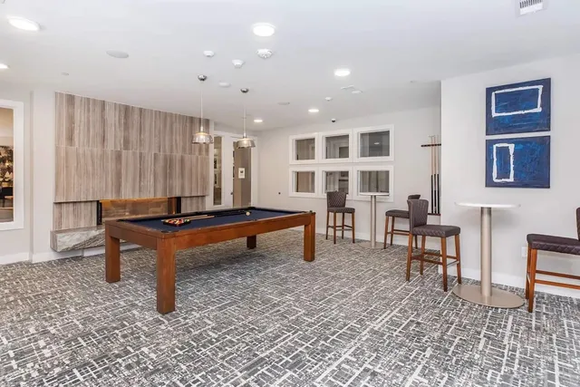 a living room with furniture a rug and a table