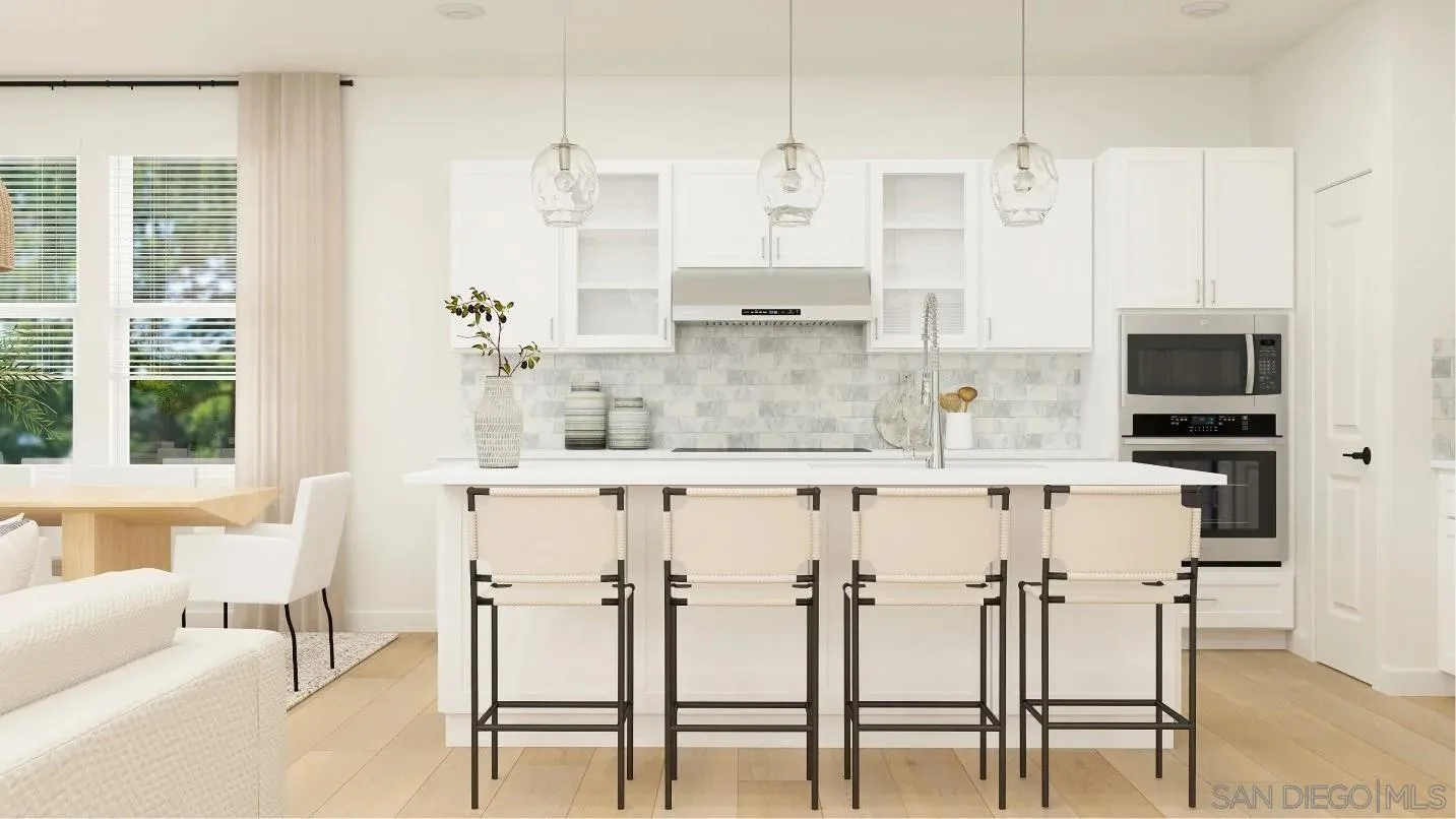 308 Triangular Road San Marcos, CA 92078 - Photo 3 of 8 a kitchen with stainless steel appliances kitchen island granite countertop a table chairs and a refrigerator