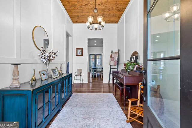 a kitchen with stainless steel appliances a refrigerator stove and white cabinets