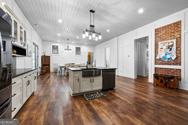 a spacious bathroom with a double vanity sink a mirror and a bathtub