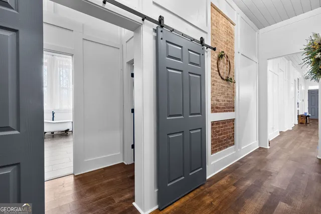 a bedroom with furniture and a flat screen tv
