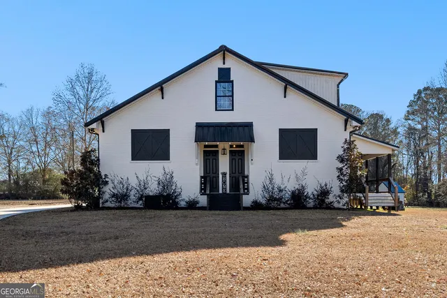 a view of the house with a yard