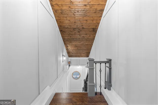 a view of a balcony with chairs and wooden fence