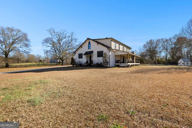 a view of kitchen with cabinets stainless steel appliances and wooden floor