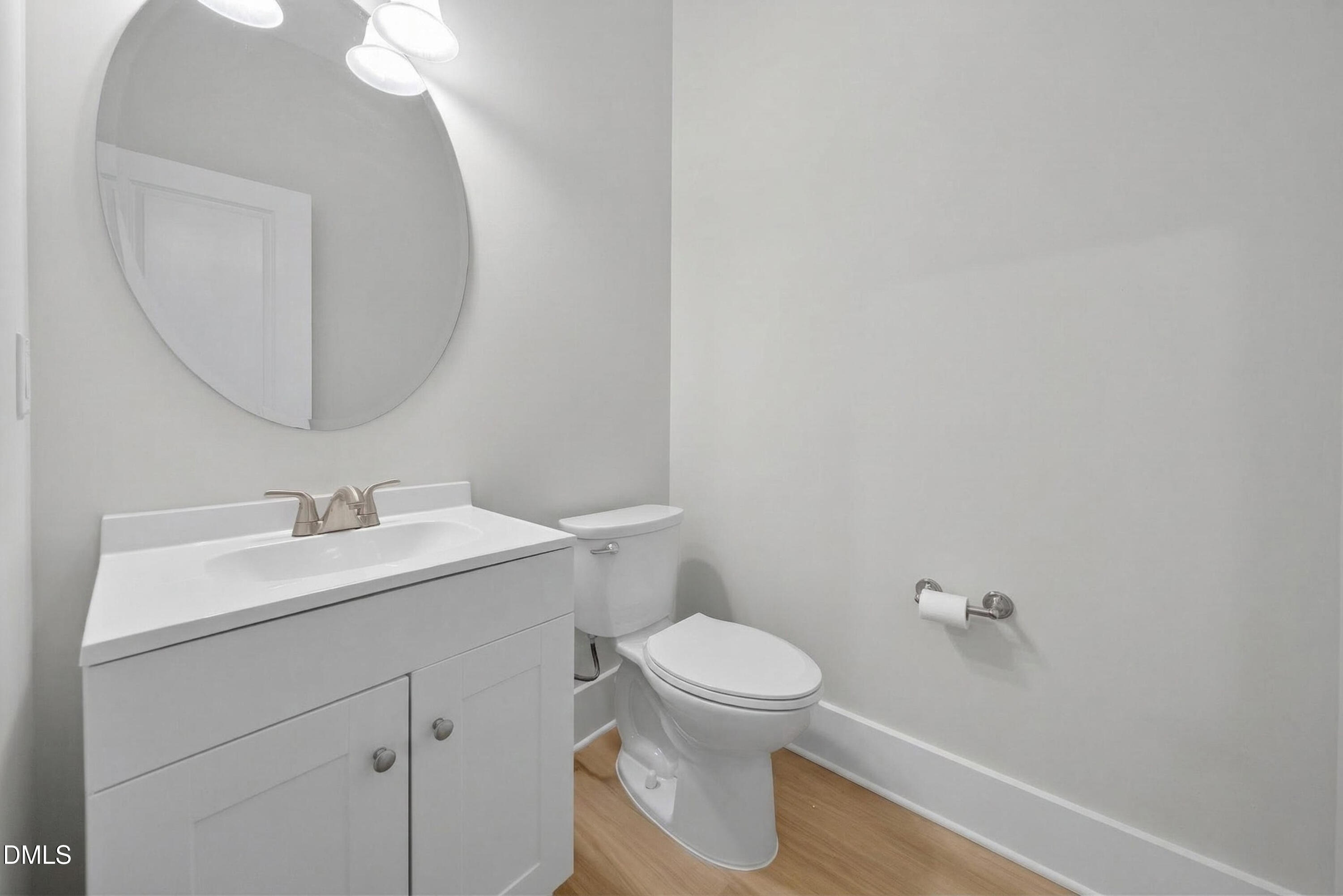 444 South Blount Street, Unit 111 Raleigh, NC 27601 - Photo 10 of 40 a bathroom with a toilet a sink and mirror