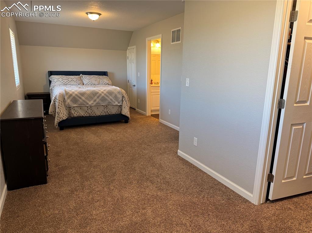 61 Stripling Lane Divide, CO 80814 - Photo 13 of 47 a room with a bed and a mirror