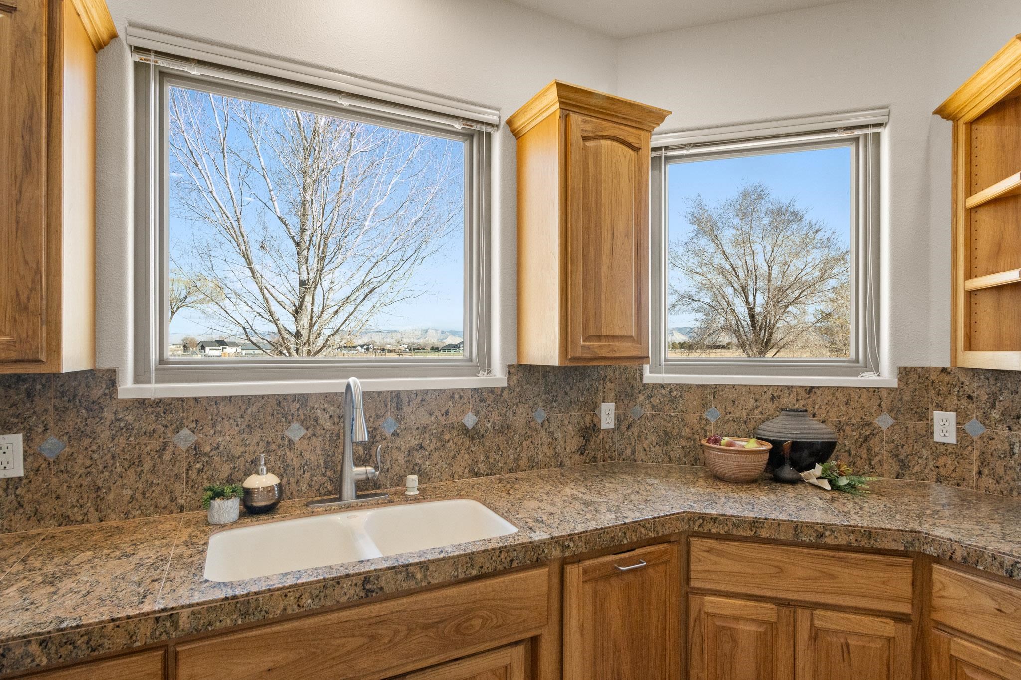 2107 I I- 1/2 Road Grand Junction, CO 81505 - Photo 12 of 42 a bathroom with a granite countertop sink a mirror and a bathtub