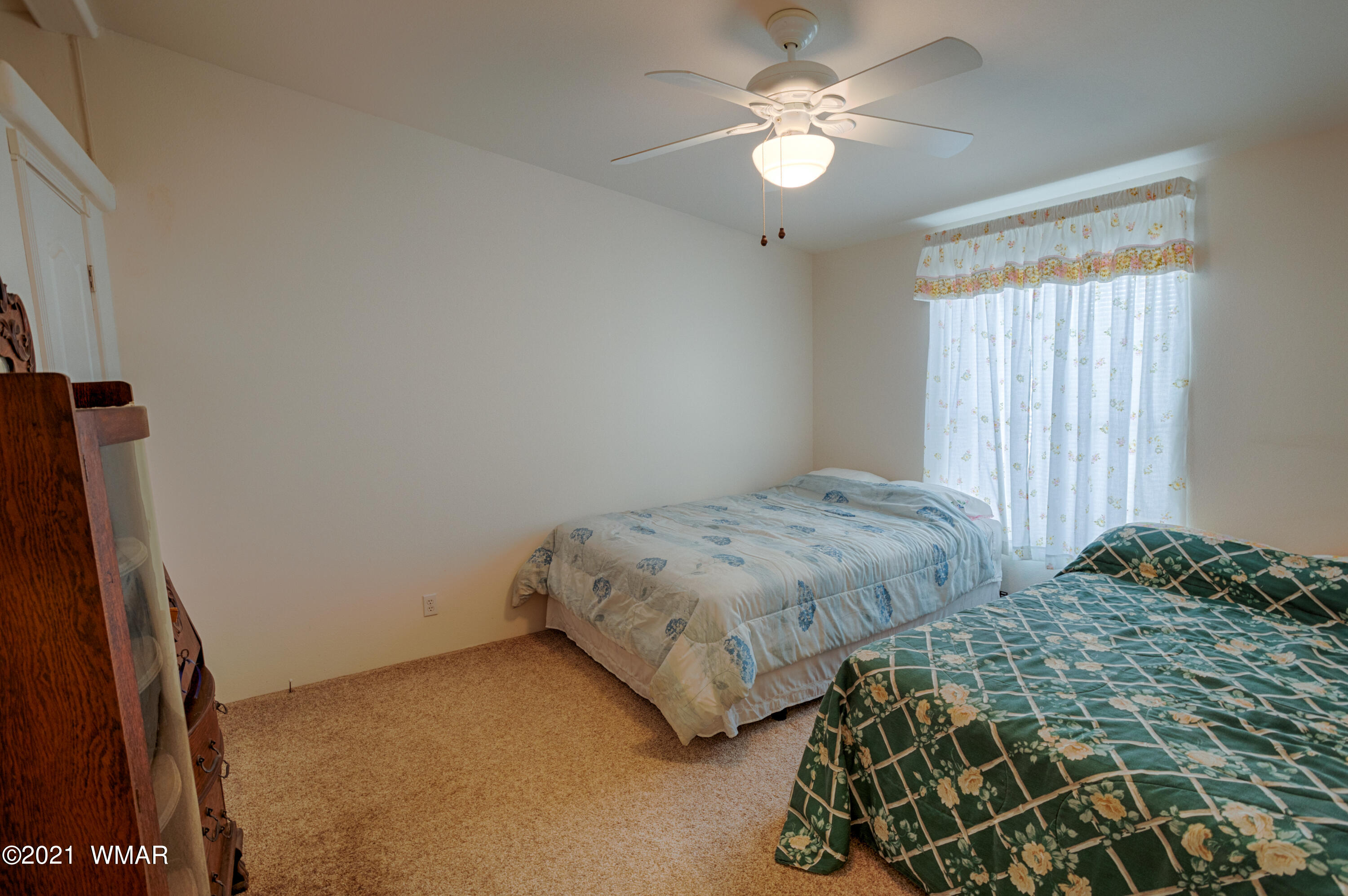 4464 Clydesdale Road Snowflake, AZ 85937 - Photo 20 of 30 a bedroom with a bed and a chandelier