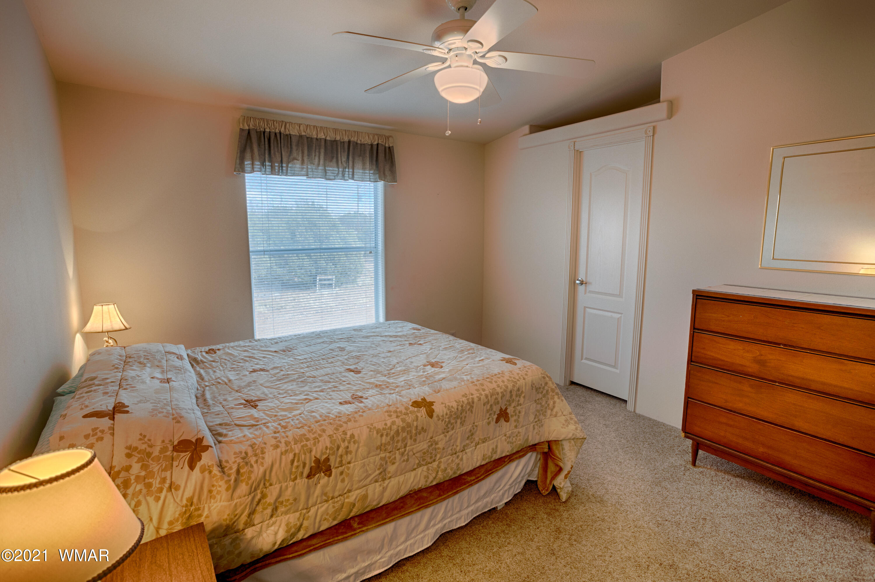 4464 Clydesdale Road Snowflake, AZ 85937 - Photo 21 of 30 a bedroom with a bed and a chandelier