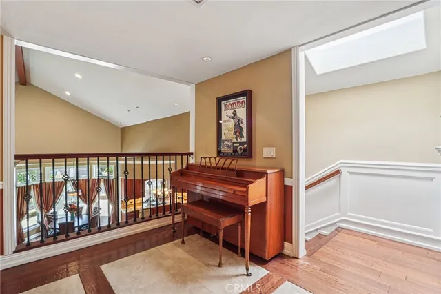 a view of a livingroom with wooden furniture and ceiling fan