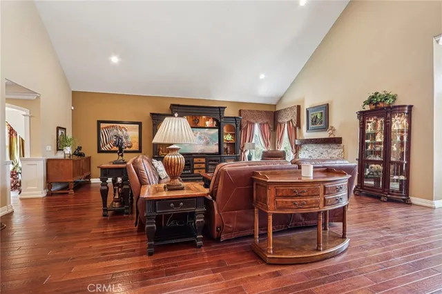 a living room with furniture fireplace and wooden floor