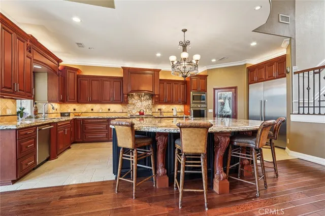 a dining room with furniture a chandelier and wooden floor