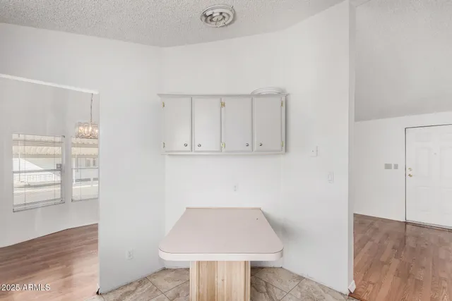 an empty room with wooden floor and cabinet