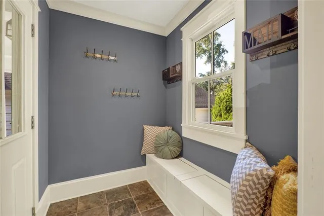 a view of a hallway with windows and stairs