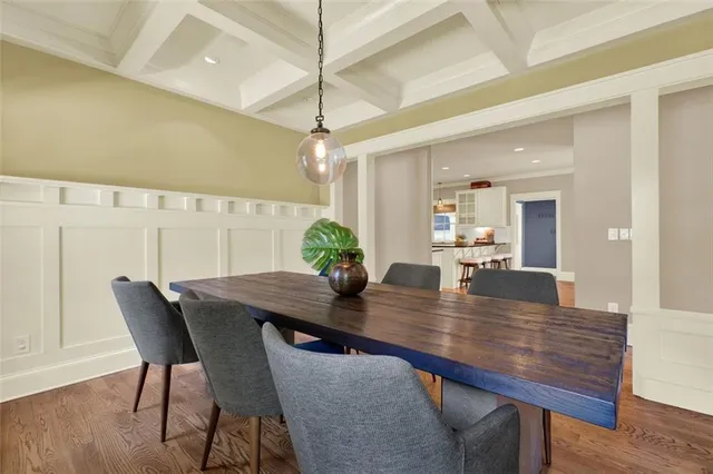 a bedroom with a large bed and chandelier