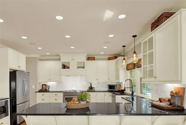 a stove top oven sitting inside of a kitchen