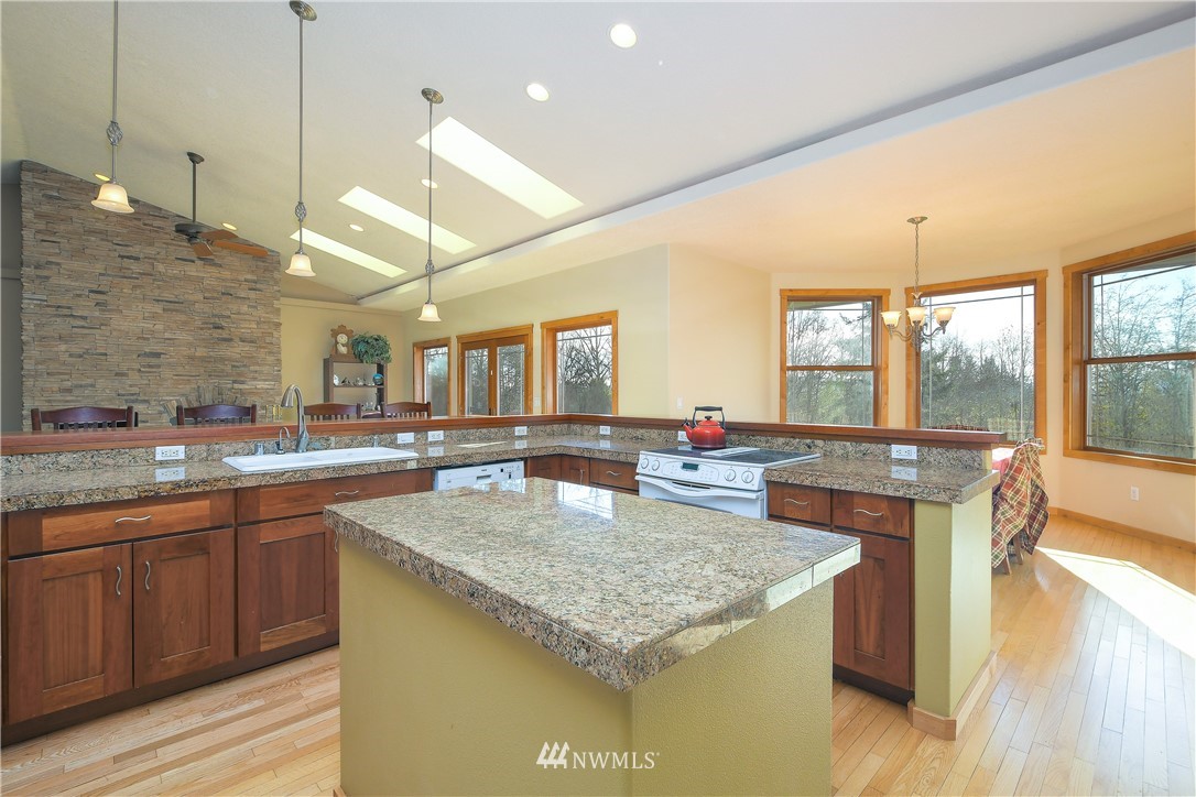 625 McAdams Road East Longview, WA 98632 - Photo 14 of 40 a kitchen with a stove a sink a counter space and living room view