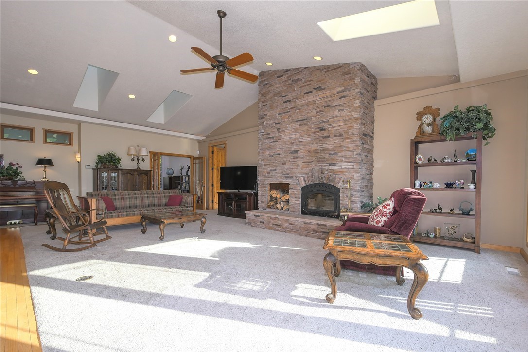 625 McAdams Road East Longview, WA 98632 - Photo 8 of 40 a living room with furniture a fireplace and a flat screen tv