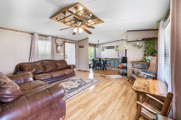 a living room with furniture and a chandelier