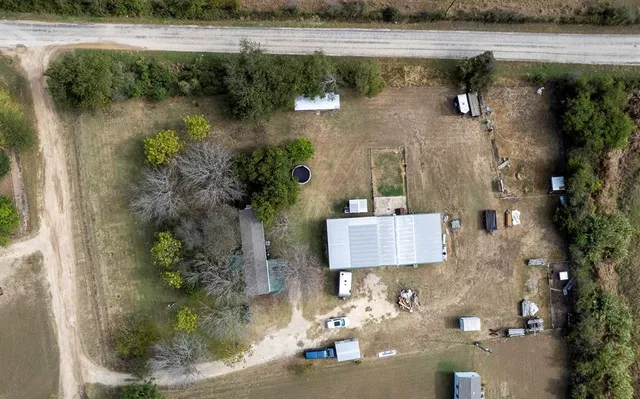 an aerial view of a house with a lake view