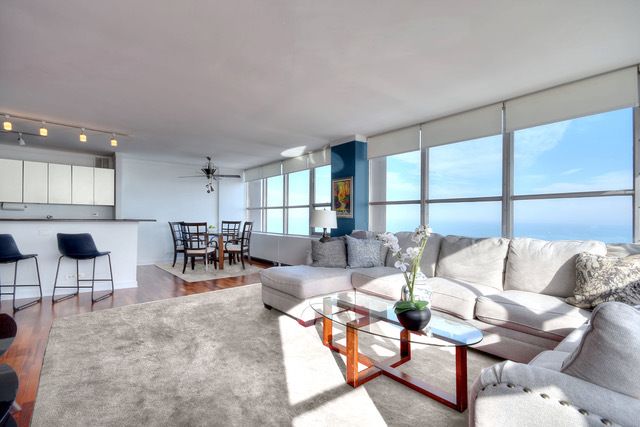 655 West Irving Park Road, Unit 4901 Chicago, IL 60613 - Photo 2 of 16 a living room with furniture and a large window