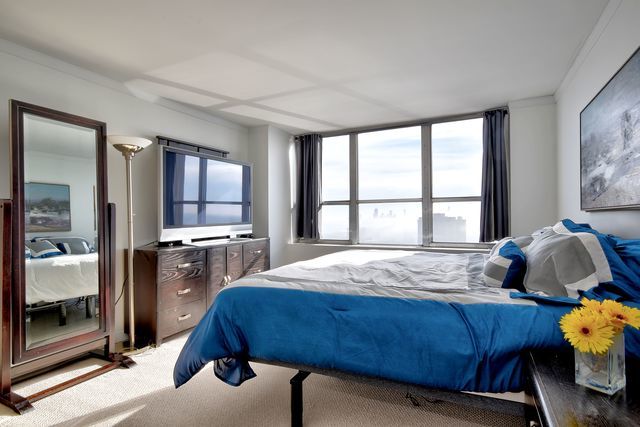 655 West Irving Park Road, Unit 4901 Chicago, IL 60613 - Photo 6 of 16 a bedroom with a bed and a window