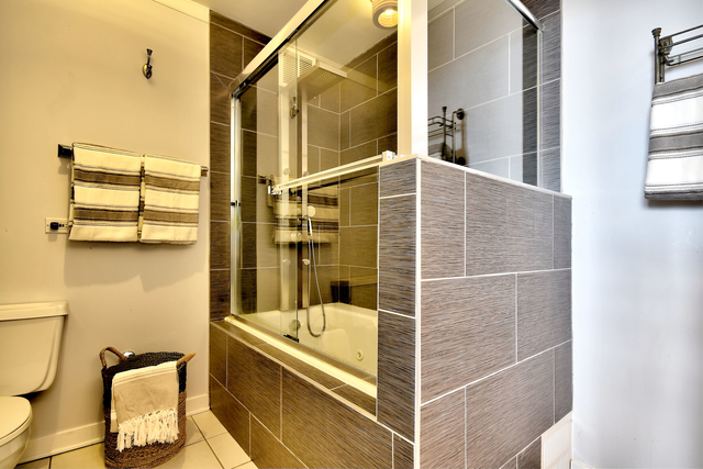 655 West Irving Park Road, Unit 4901 Chicago, IL 60613 - Photo 7 of 16 a bathroom with a tub and shower