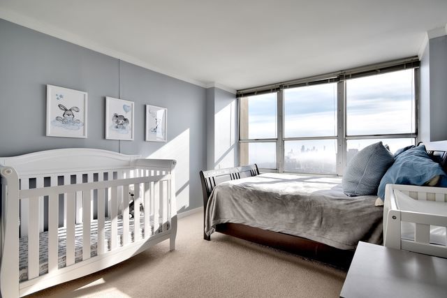 655 West Irving Park Road, Unit 4901 Chicago, IL 60613 - Photo 9 of 16 a bedroom with a bed and a large window