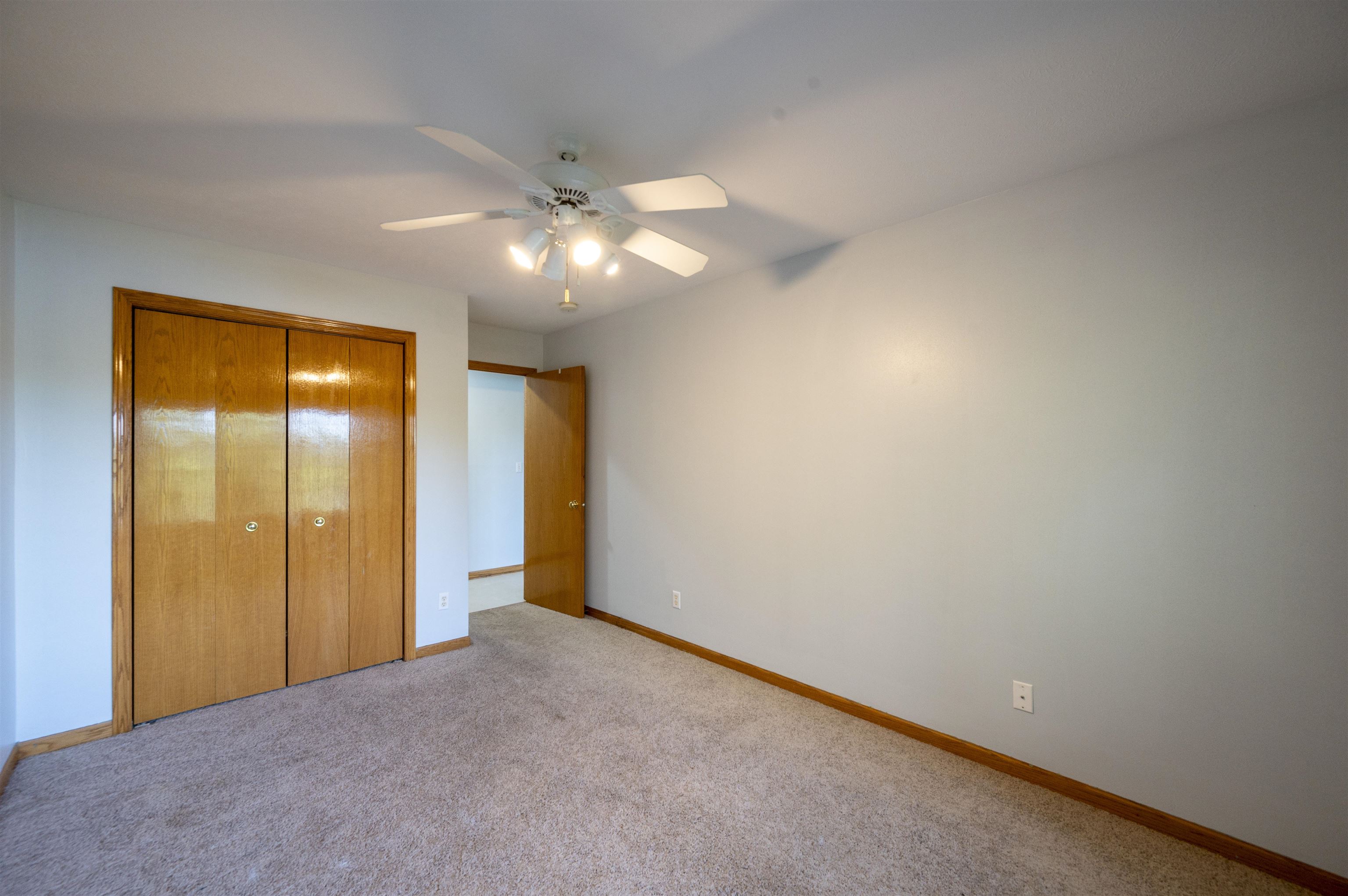 7280 North Alpine Road Loves Park, IL 61111 - Photo 13 of 17 a view of an empty room with chandelier fan