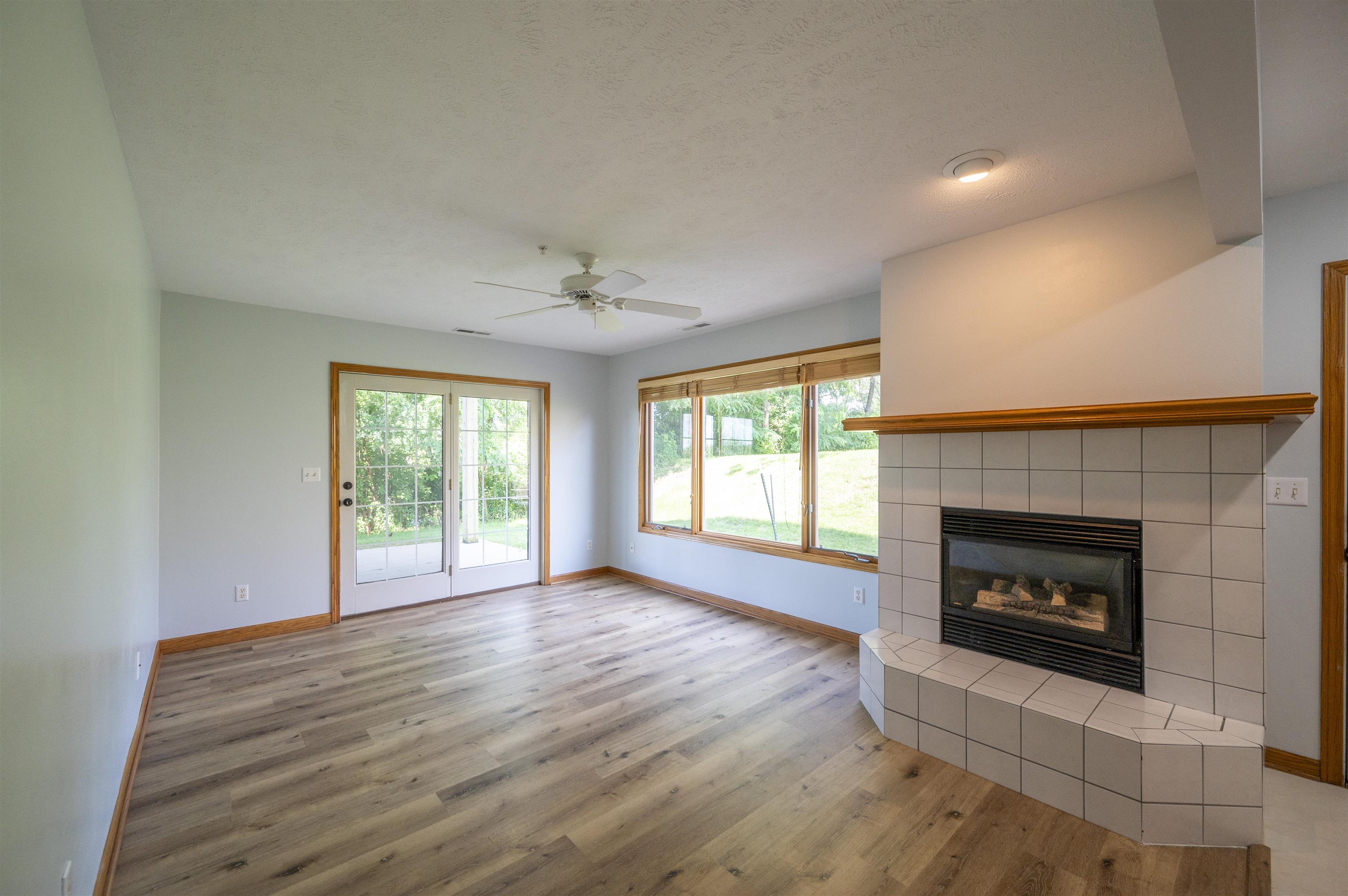 7280 North Alpine Road Loves Park, IL 61111 - Photo 7 of 17 a view of an empty room with a fireplace and a window