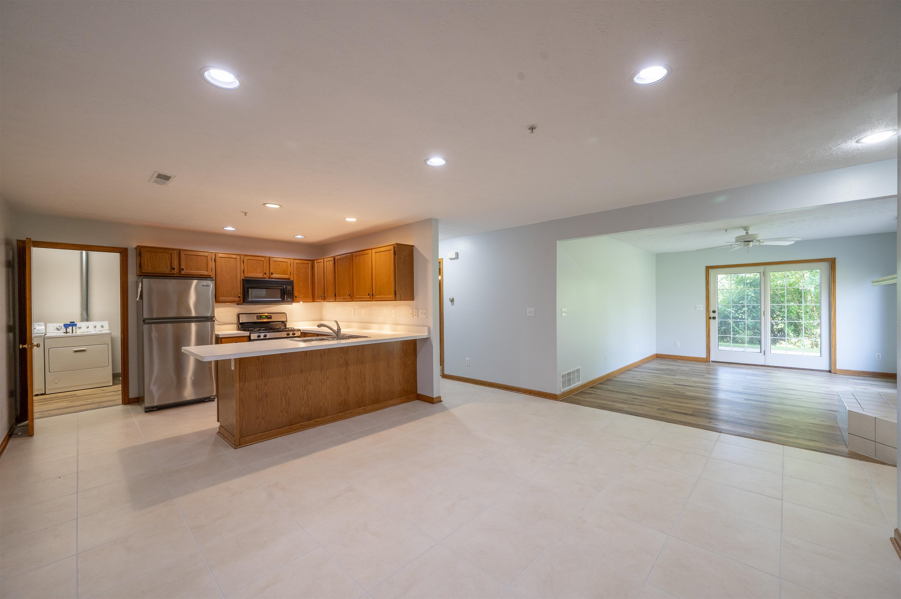 7280 North Alpine Road Loves Park, IL 61111 - Photo 10 of 17 a large hall with stainless steel appliances granite countertop a large counter top a stove and a refrigerator