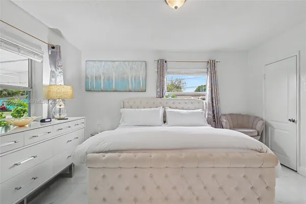 a bedroom with two bed and a night stand