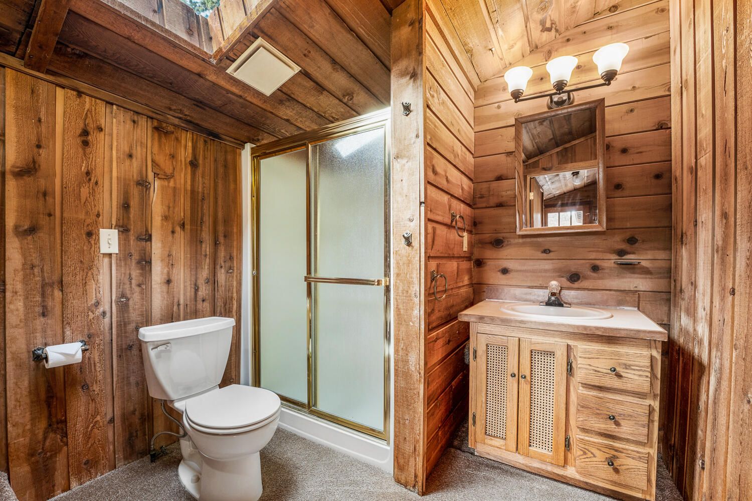 62255 Wallace Road Bend, OR 97701 - Photo 17 of 51 a bathroom with a granite countertop toilet sink and mirror