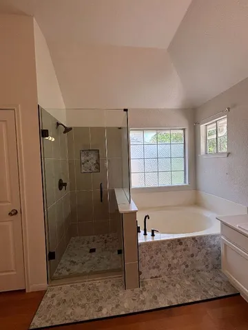 a bath tub sitting in a bathroom next to a window