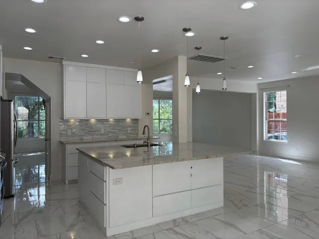 a kitchen with a sink stove and cabinets