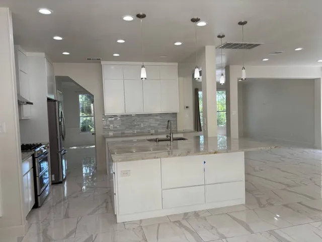 a large bathroom with a large mirror vanity and shower
