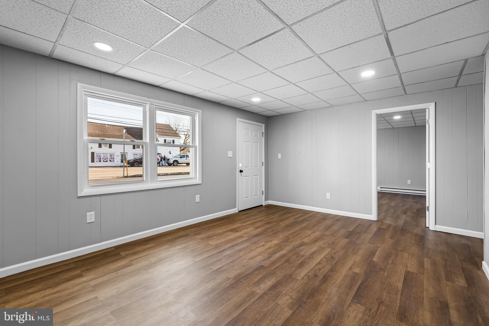 1480 Seven Valleys Road, Unit 3 York, PA 17408 - Photo 3 of 17 a view of an empty room with wooden floor and a window