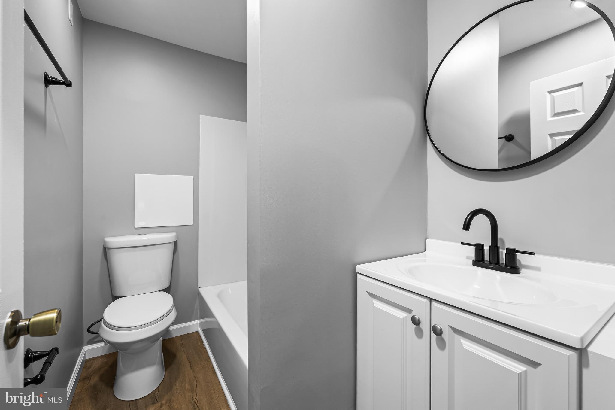 1480 Seven Valleys Road, Unit 3 York, PA 17408 - Photo 7 of 17 a bathroom with a toilet sink and mirror