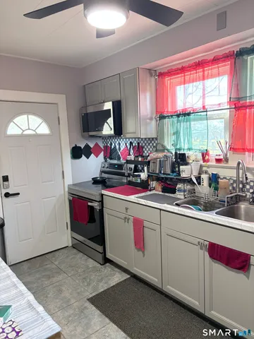 a kitchen that has a sink cabinets and window