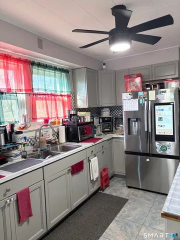 a kitchen with stainless steel appliances granite countertop a refrigerator sink and cabinets