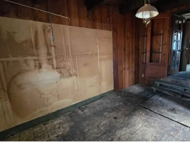 a view of a room with a table and chairs