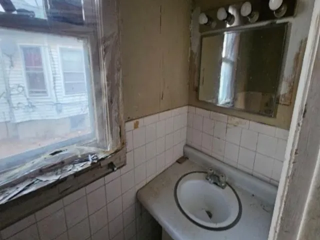 a bathroom with a sink and mirror